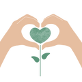 Hände bilden ein Herz mit grüner Pflanze